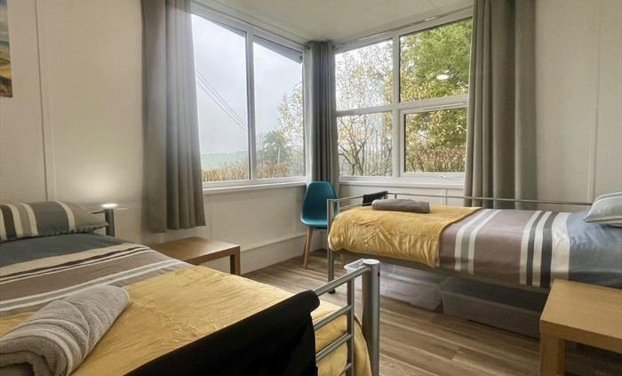 Our bedrooms are simple, comfortable & spacious. On arrival your bed will be made up ready for you, we provide storage under your beds, and a towel. W